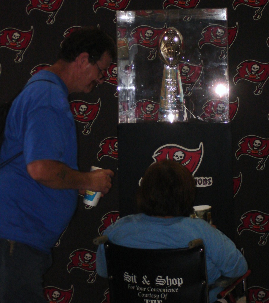 Fans take a solemn moment to pay respect to the Bucs' treasured Vince Lombardi Trophy.