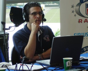 Adam Schein of Sirius NFL Radio listens intently to an interviewee. 