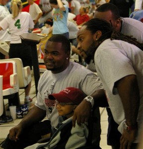 Bucs fullback Chris Pressley (left) and Kareem Huggins share a moment with a young fan at Earnest Graham's charity bowling event in Fort Myers. Graham's foundation, Earnest Giving, is helping kids with cancer. (Photo by Kyra Hallett, JoeBucsFan.com)