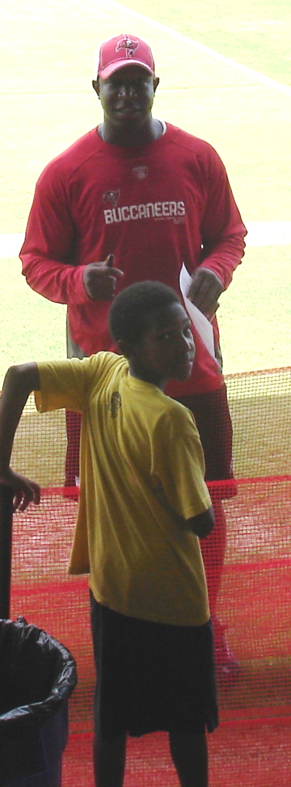 Raheem the Dream signs an autograph for a young fan.