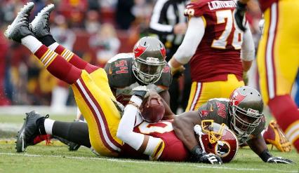 Clinton McDonald and Lavonte David put Robert Griffin III on his back for one of the six Bucs sacks today. (Photo courtesy of Buccaneers.com)