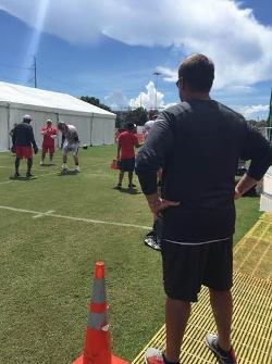 Bucs AC/DC-loving general manager Jason Licht monitors offensive line workouts Tuesday. Photo courtesy Chris Fischer/WTSP-TV.