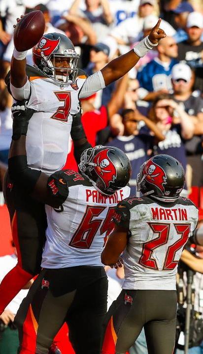 Kevin Pamphile and Doug Martin join America's Quarterback in celebrating the game-winning touchdown yesterday. More celebrating happened in the locker room. (Photo courtesy of Buccaneers.com.)