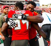 Bucs DT Akeem Spence hugs LB Lavonte David after his victory-clinching pick. Spence believes divine intervention played a hand in Jameis' 20-yard run to save the season. (Photo courtesy of Buccaneers.com.) 