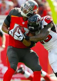 Bucs TE Austin Seferian-Jenkins takes a hit in the win over Atlanta. (Photo courtesy of Buccaneers.com).