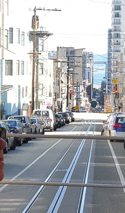 Seeing the water in the distance while sightseeing the city on a cable car.