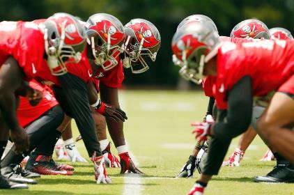 Fingers on the line at the first Bucs practice under head coach Dirk Koetter Tuesday at One Buc Palace. (Photo Courtesy of Buccaneers.com.)