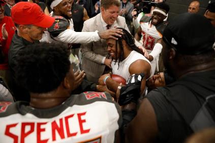 Jacquizz Rodgers is mobbed after being awarded the game ball last night.